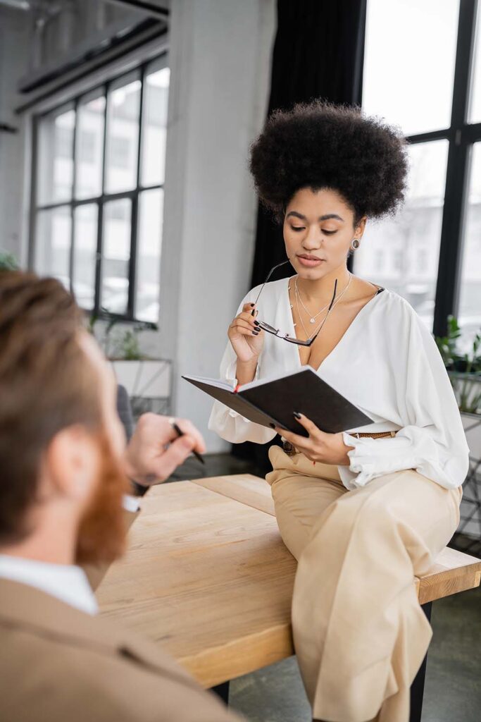 sexy african american businesswoman holding glasse QS5N46G