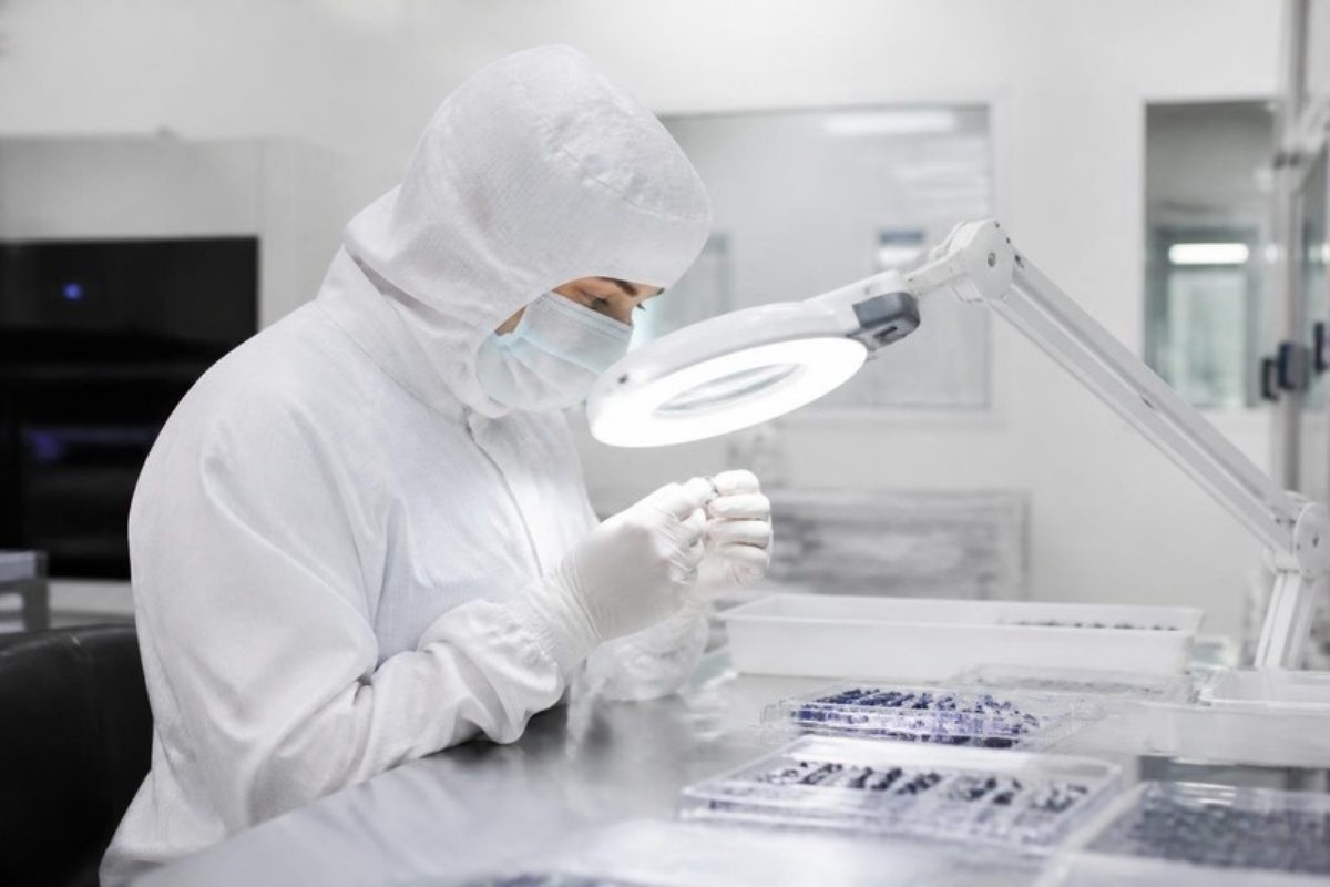 Cleanroom technician inspecting medical device components — ISO 13485 medical device quality